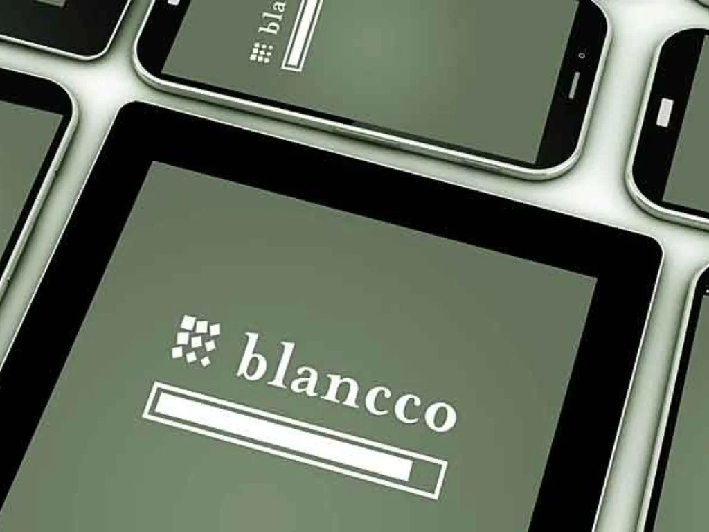 Close-up of several tablets showing a green login screen with a white brand logo and a long blank password field.