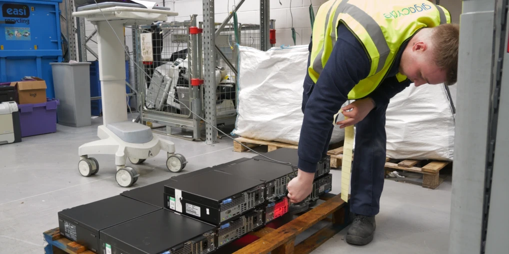 IT equipment with asset labels being processed and documented as part of a secure destruction log.