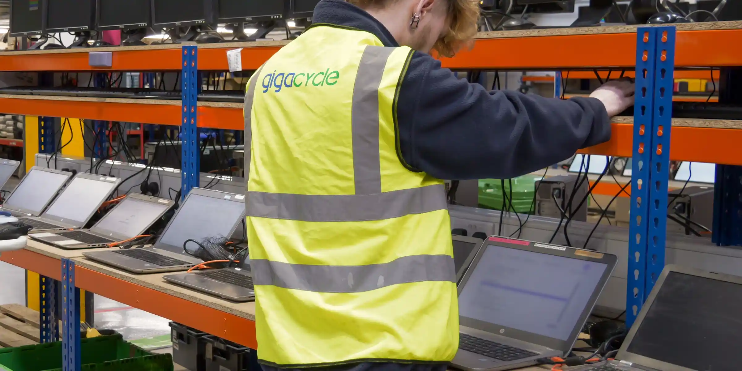 Worker processing IT equipment for secure data disposal and reuse