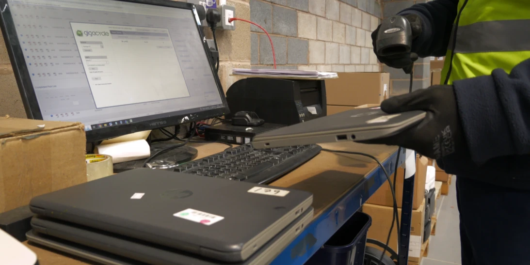 IT equipment being scanned and recorded into an asset tracking system during the IT asset disposal process.